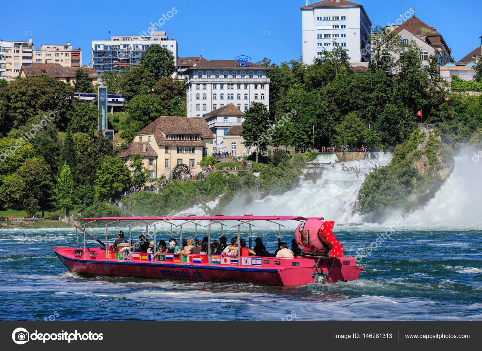 Neuhausen am Rheinfall, Switzerland - 22 June, 2016: people in a boat at the Rhine Falls, selective focus on the main subject, somewhat blurry background. The Rhine Falls (German: Rheinfall) is the largest plain waterfall in Europe, located on the Rhine river between the municipalities of Neuhausen am Rheinfall in the Swiss canton of Schaffhausen and Laufen-Uhwiesen in the Swiss canton of Zurich.